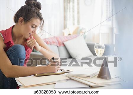 Woman at home writing View Large Photo Image Stock Photo - Woman at home writing. Fotosearch