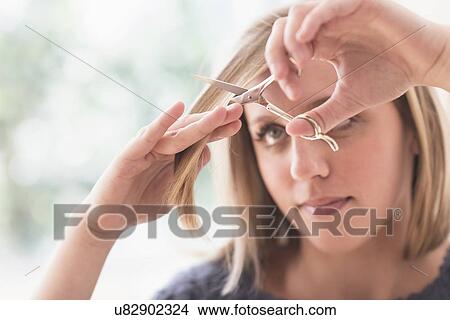 Woman cutting hair View Large Photo Image Picture - Woman cutting hair. Fotosearch