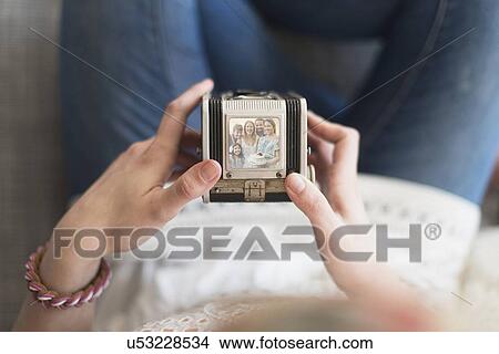 Picture - Woman holding antique camera. Fotosearch