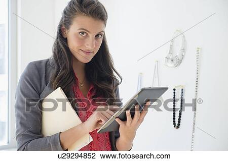 Woman in store with tablet View Large Photo Image Stock Image - Woman in store with tablet. Fotosearch