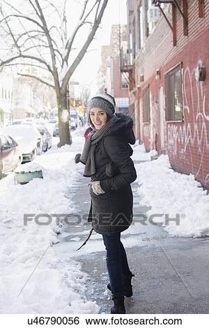 Stock Photograph - Woman in winter city. Fotosearch