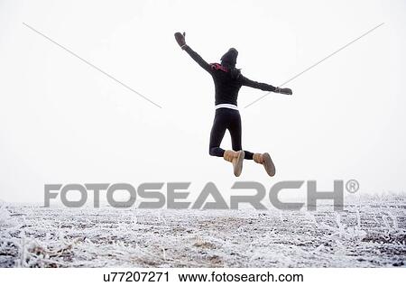Woman jumping outdoors View Large Photo Image Stock Image - Woman jumping outdoors. Fotosearch