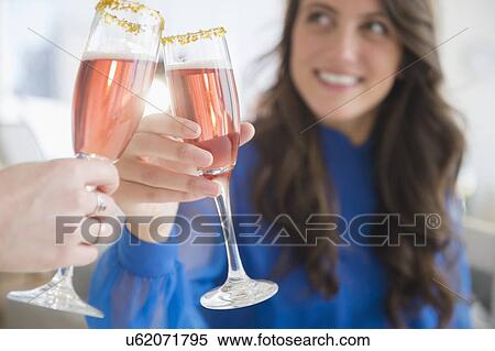 Woman making a toast with another View Large Photo Image Stock Photography - Woman making a toast with another. Fotosearch