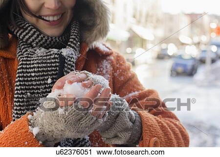 Woman making snowball in street View Large Photo Image Stock Image - Woman making snowball in street. Fotosearch