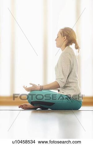 Woman meditating on floor View Large Photo Image Picture - Woman meditating on floor. Fotosearch