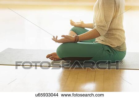 Woman meditating on floor View Large Photo Image Picture - Woman meditating on floor. Fotosearch