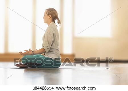 Woman meditating on floor View Large Photo Image Picture - Woman meditating on floor. Fotosearch
