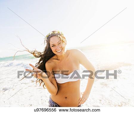 Woman on beach making victory sign View Large Photo Image Stock Photograph - Woman on beach making victory sign. Fotosearch