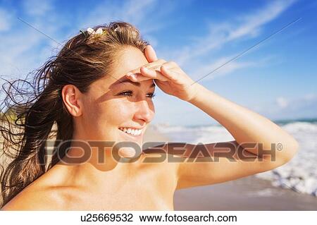 Woman on beach shielding eyes View Large Photo Image Stock Image - Woman on beach shielding eyes. Fotosearch