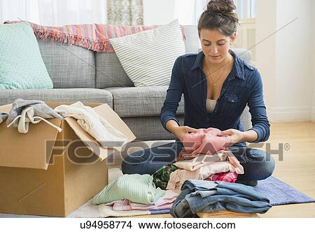 Woman packing clothes to box View Large Photo Image Picture - Woman packing clothes to box. Fotosearch
