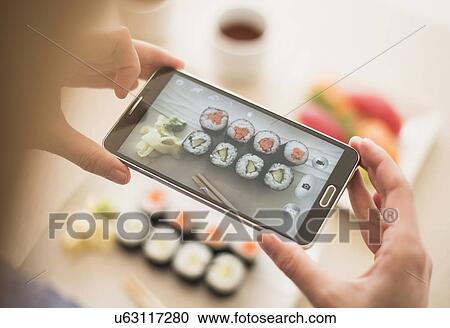 Woman photographing sushi set View Large Photo Image Stock Image - Woman photographing sushi set. Fotosearch