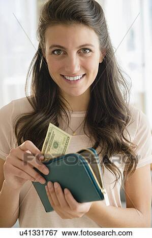 Woman putting banknote to wallet View Large Photo Image Stock Photo - Woman putting banknote to wallet. Fotosearch