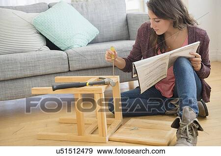 Woman putting together stool View Large Photo Image Stock Photo - Woman putting together stool. Fotosearch
