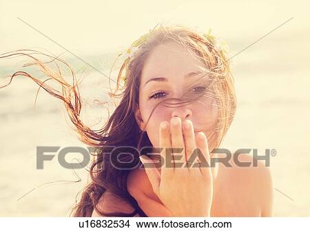Woman throwing a kiss on beach View Large Photo Image Picture - Woman throwing a kiss on beach. Fotosearch