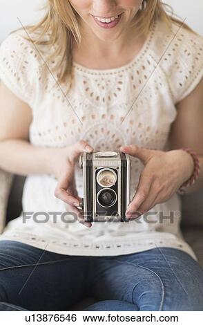 Stock Photograph - Woman using antique camera. Fotosearch