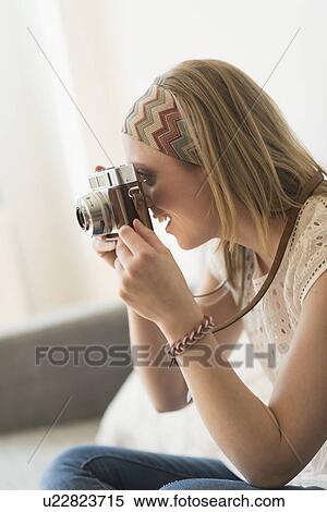 Stock Photography - Woman using antique camera. Fotosearch