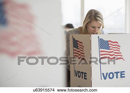 Picture - Woman voting on election day. Fotosearch