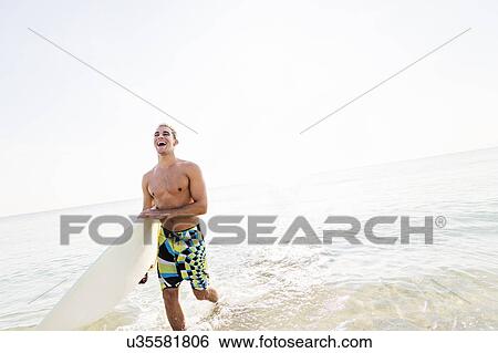 Young surfer laughing View Large Photo Image Stock Photograph - Young surfer laughing. Fotosearch