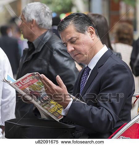 Stock Photography - "Businessman reading a magazine, Santiago, Santiago Metropolitan Region, Chile". Fotosearch