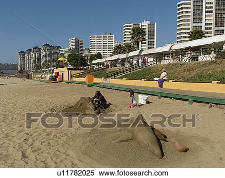 Stock Photography - "Man making sand sculpture on the beach, Vina Del Mar, Chile". Fotosearch
