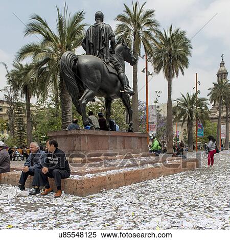 Stock Photography - "People sitting around an equestrian statue, Santiago, Santiago Metropolitan Region, Chile". Fotosearch