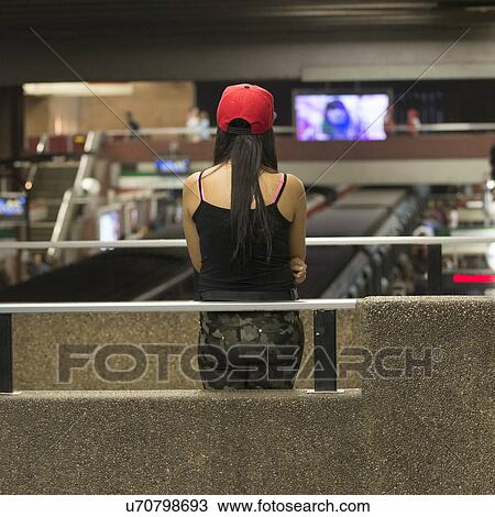 Stock Image - "Rear view of a woman standing at Santiago Metro station, Santiago, Santiago Metropolitan Region, Chile". Fotosearch