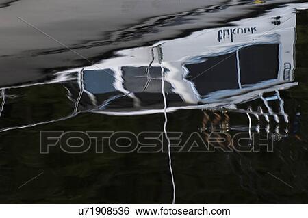 Stock Photograph - "Reflection of a boat on water, Skeena-Queen Charlotte Regional District, Haida Gwaii, Graham Island, British Columbia, Canada". Fotosearch