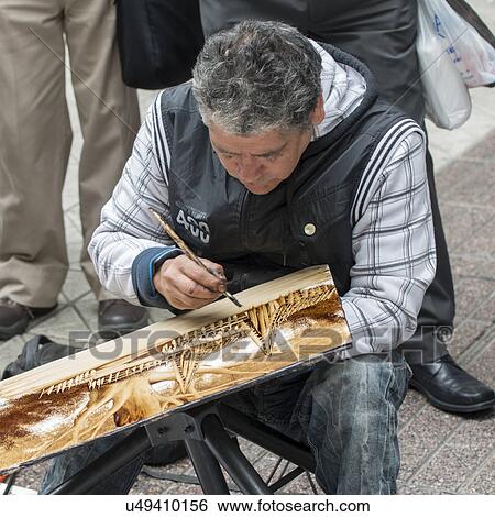 Stock Photograph - "Street Artist making a painting, Santiago, Santiago Metropolitan Region, Chile". Fotosearch