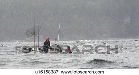 Stock Photo - "Tourists fishing in the Pacific Ocean, Skeena-Queen Charlotte Regional District, Haida Gwaii, Graham Island, British Columbia, Canada". Fotosearch