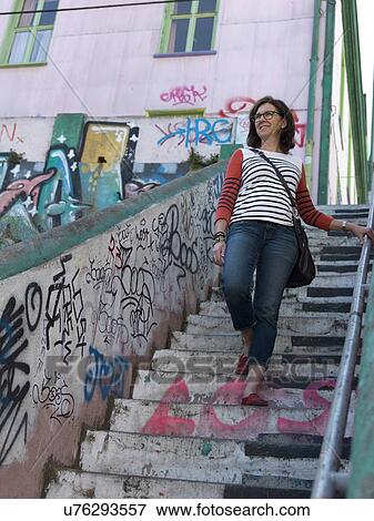 "Woman walking down stairs, Valparaiso, Chile" View Large Photo Image Stock Photo - "Woman walking down stairs, Valparaiso, Chile". Fotosearch