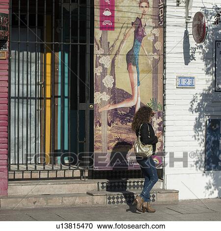 "Woman walking in front of a house, Santiago, Santiago Metropolitan Region, Chile" View Large Photo Image Stock Image - "Woman walking in front of a house, Santiago, Santiago Metropolitan Region, Chile". Fotosearch