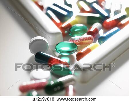 Stock Photo - A range of medicine falling out of a counting triangle. Fotosearch
