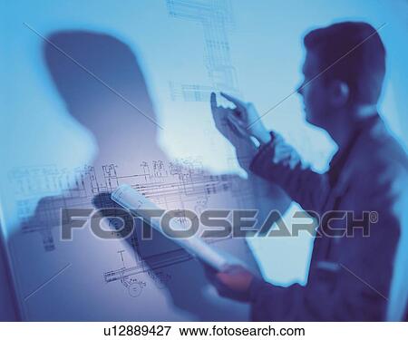 Stock Photo - Architect studying drawings. Fotosearch