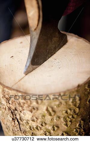 Stock Image - "Axe splitting wood, close-up". Fotosearch