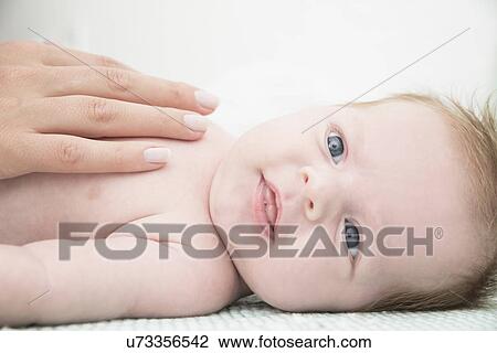 Stock Image - Baby on bed. Fotosearch