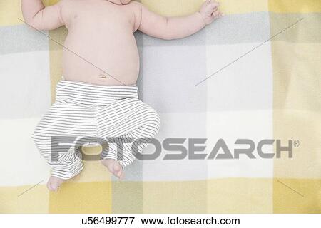 Stock Photo - Baby on bed. Fotosearch