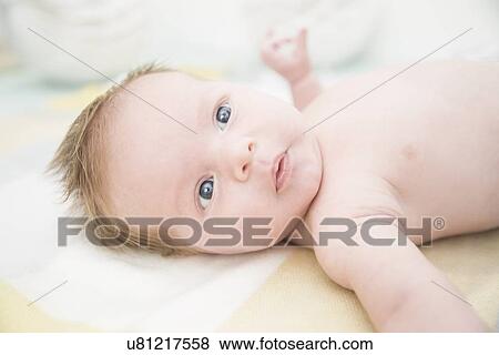 Stock Photo - Baby on bed. Fotosearch