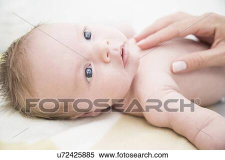 Stock Photography - Baby on bed. Fotosearch