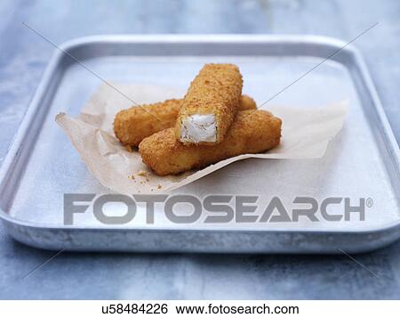 Baking tin with fried chunky breaded fish fingers on steel table View Large Photo Image Stock Photograph - Baking tin with fried chunky breaded fish fingers on steel table. Fotosearch