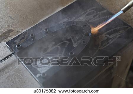 "Blowtorch on metal in workshop, close-up" View Large Photo Image Stock Image - "Blowtorch on metal in workshop, close-up". Fotosearch