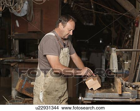 Boat builder in workshop View Large Photo Image Picture - Boat builder in workshop. Fotosearch