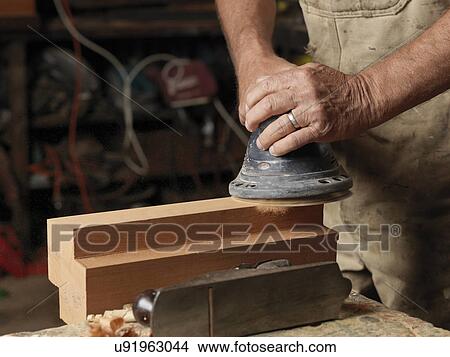 Boat builder sanding wood in workshop View Large Photo Image Picture - Boat builder sanding wood in workshop. Fotosearch
