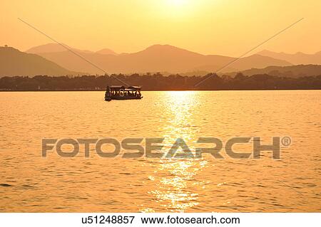 "Boat on lake at sunset, Hangzhou, China" View Large Photo Image Stock Photo - "Boat on lake at sunset, Hangzhou, China". Fotosearch