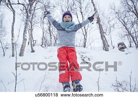 "Boy jumping down snow covered hill, Hemavan, Sweden" View Large Photo Image Stock Photo - "Boy jumping down snow covered hill, Hemavan, Sweden". Fotosearch