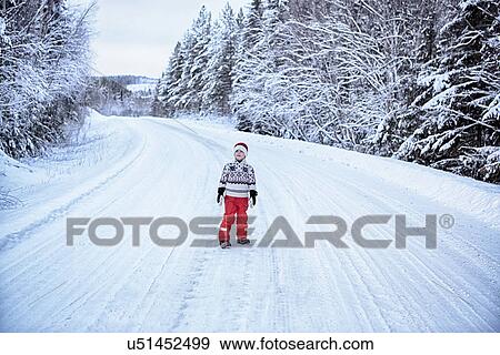 "Boy looking up from snow covered highway, Hemavan, Sweden" View Large Photo Image Stock Photo - "Boy looking up from snow covered highway, Hemavan, Sweden". Fotosearch