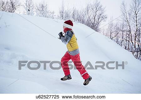 "Boy running up snow covered hill, Hemavan, Sweden" View Large Photo Image Stock Photography - "Boy running up snow covered hill, Hemavan, Sweden". Fotosearch