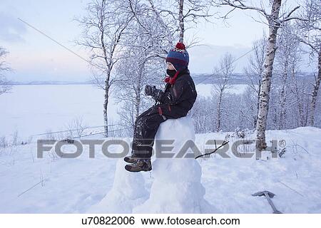"Boy sitting on top of snow man, Hemavan, Sweden" View Large Photo Image Stock Photograph - "Boy sitting on top of snow man, Hemavan, Sweden". Fotosearch
