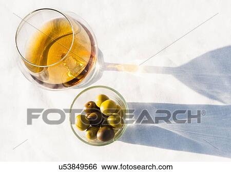 Brandy glass and olives on sunlit table View Large Photo Image Stock Photograph - Brandy glass and olives on sunlit table. Fotosearch
