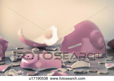 Stock Photo - Broken piggy bank and coins. Fotosearch