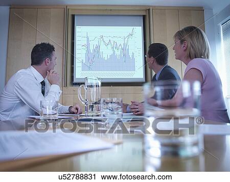 Business colleagues looking at screen in meeting View Large Photo Image Stock Image - Business colleagues looking at screen in meeting. Fotosearch
